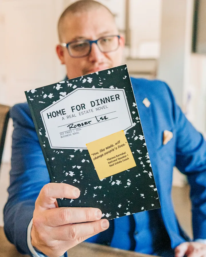 Rob Lee holding his novel, Home for Dinner